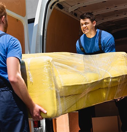 selective-focus-movers-unloading-sofa-stretch-wrap-truck-outdoors marco